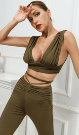 Open-back top and high-waisted bootcut trousers.